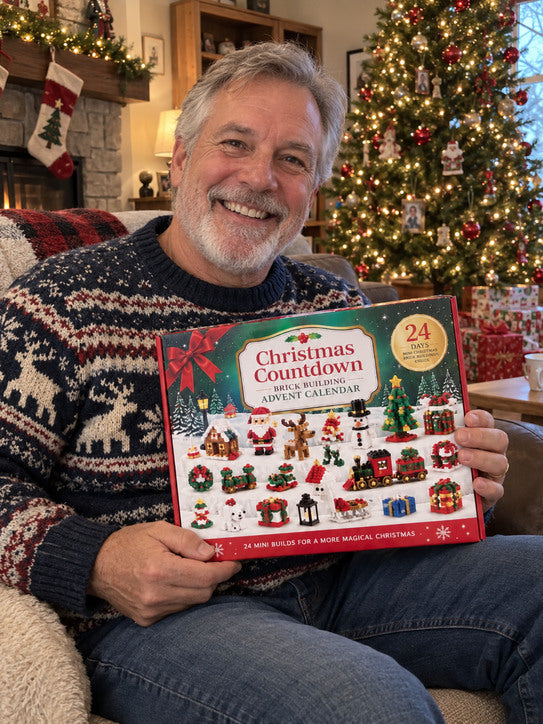 Older man in a holiday sweater holding the calendar near a Christmas tree.