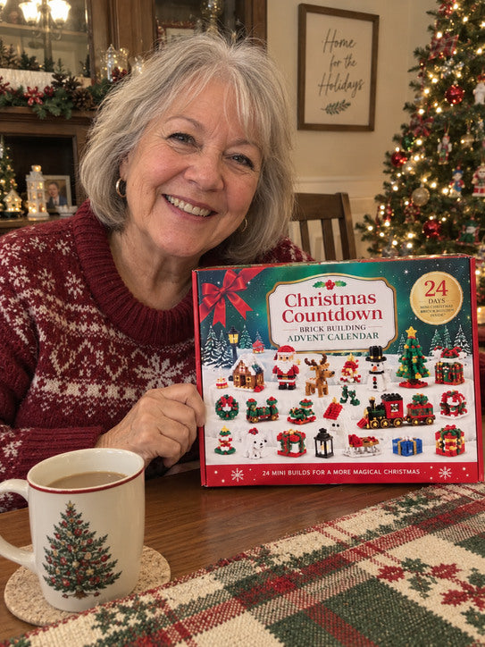 Older woman at a dining table holding the Christmas advent calendar.
